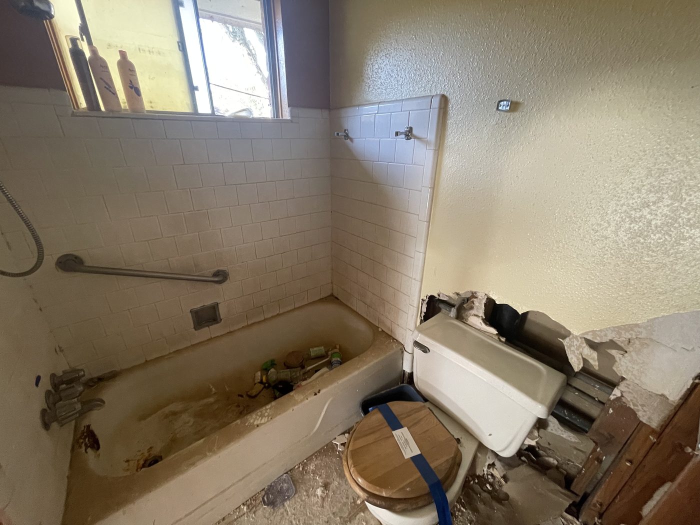 Gutted Friendswood bathroom mid-demolition