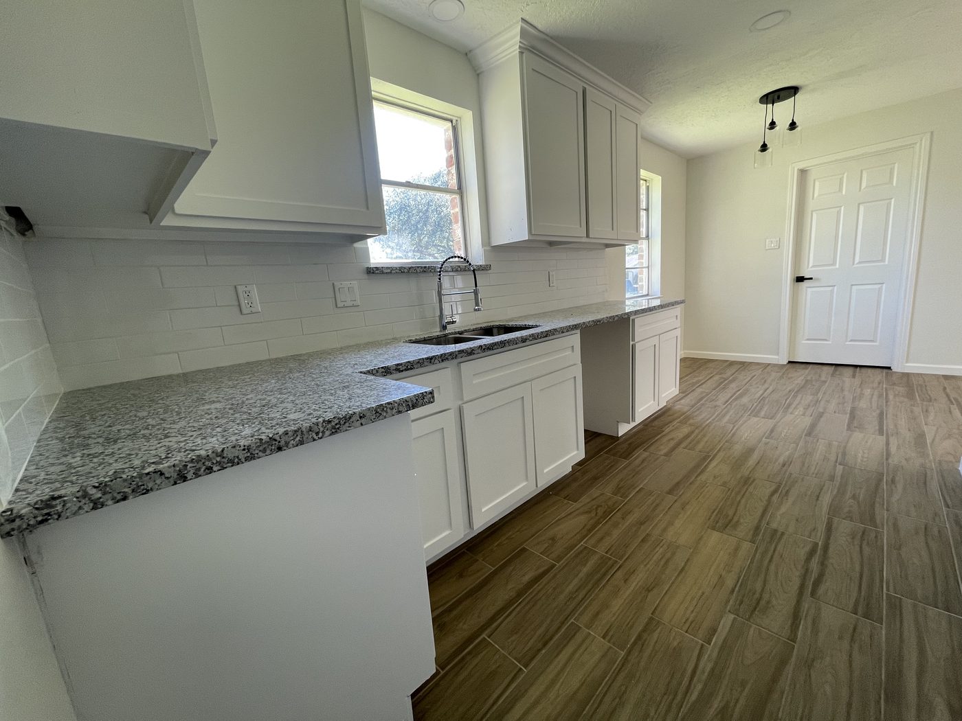 The finished kitchen with granite counters and new cabinets