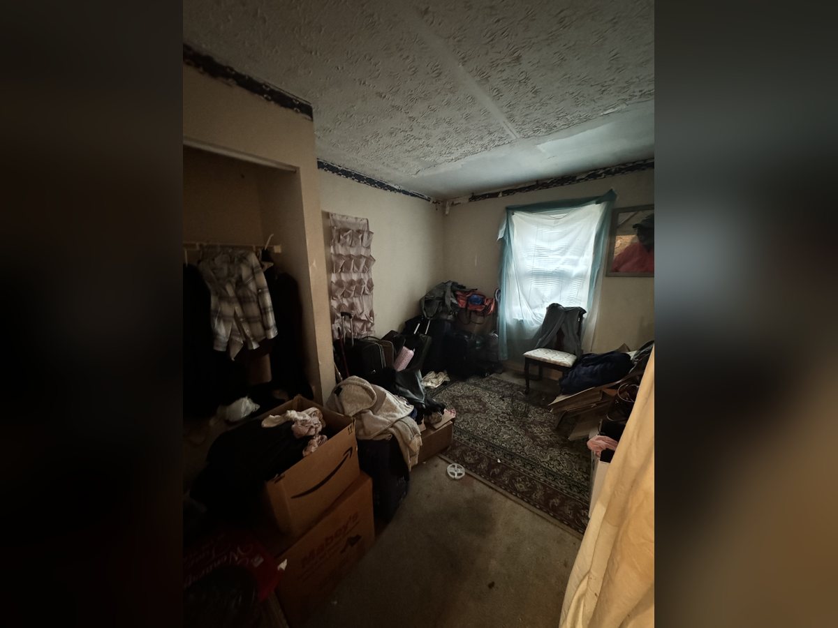 Wendell bedroom fully occupied at walkthrough, packed with belongings