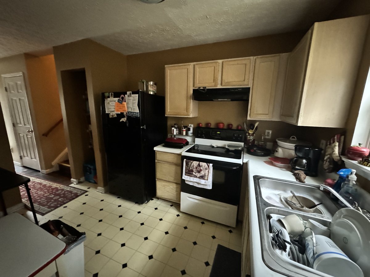 The Wendell kitchen as found, with dated cabinets and worn vinyl flooring